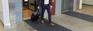 Man leaving lift across anti-static mat