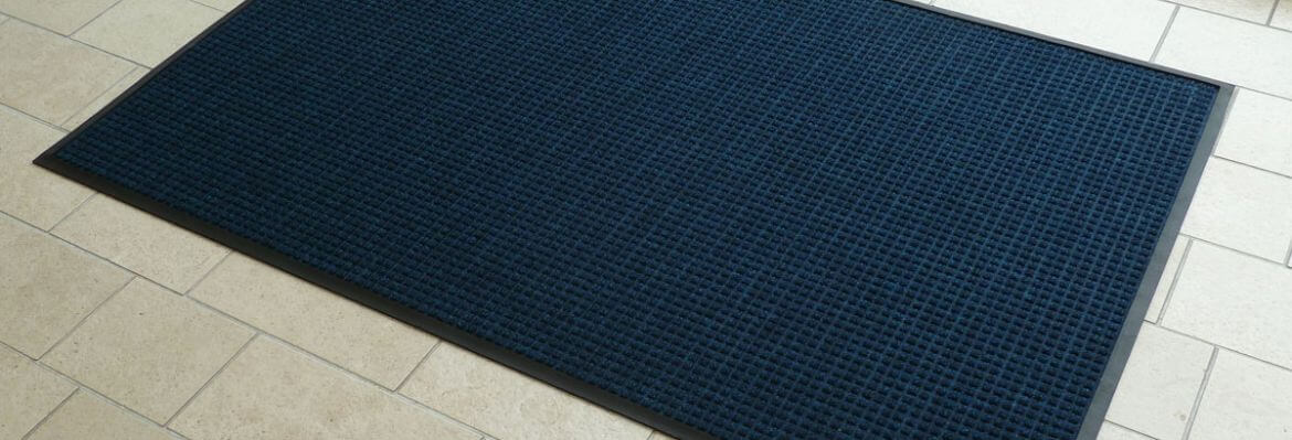 Large blue fabric and rubber backed stock entrance door mat